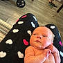 Gwendolyn joined the competition — help win amazing prizes! baby, infant, diaper, person, legs, lap, pajamas, heart_pattern, floor, stroller, wheel, indoor, wood_floor, carpet, footwear, toy, furniture, curious, skin, relaxing