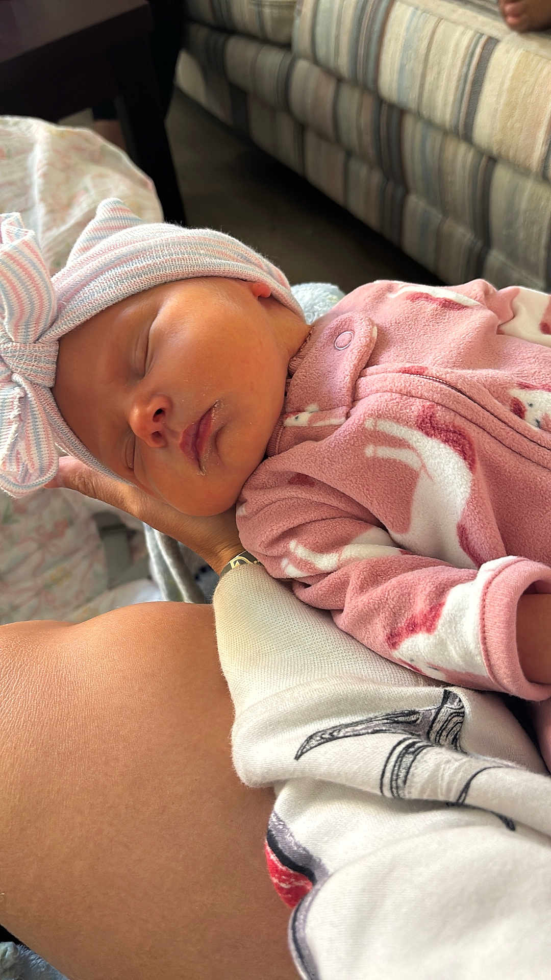 Gwendolyn is registered to the contest to win money with this photo: newborn, baby, sleeping, pink_clothing, hat, bow, arm, resting, indoor, couch, fabric, cozy, peaceful, infant, portrait, person, closeup, skin, hand, relaxation