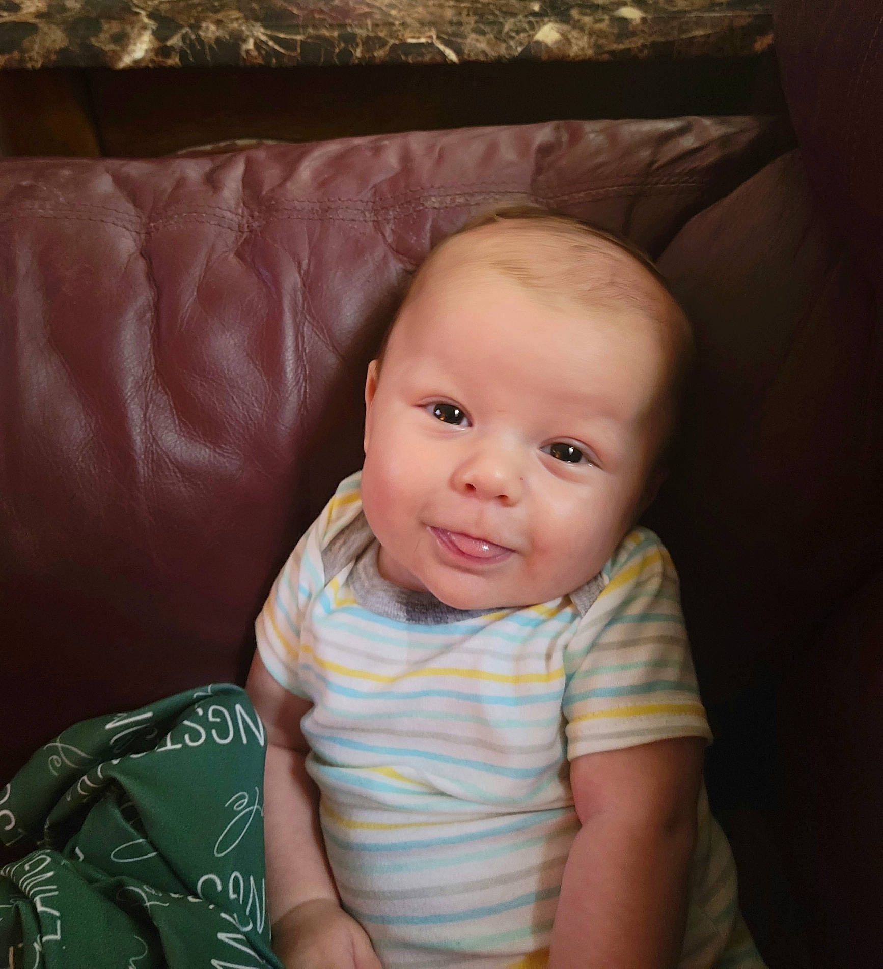 Langston is registered to the contest to win money with this photo: baby, baby_toddler_clothing, cheek, child, comfort, couch, eye, eyebrow, eyelash, flash_photography, fun, iris, lip, mouth, nose, person, skin, sleeve, smile, toddler