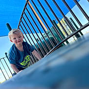 Gunnar joined the competition — help win amazing prizes! child, toddler, playground, climbing, blue_sky, metal_bars, outdoor, smiling, blonde_hair, tshirt, dinosaur_print, daylight, recreation, fun, play, young_child, happy, person, casual_clothing, park
