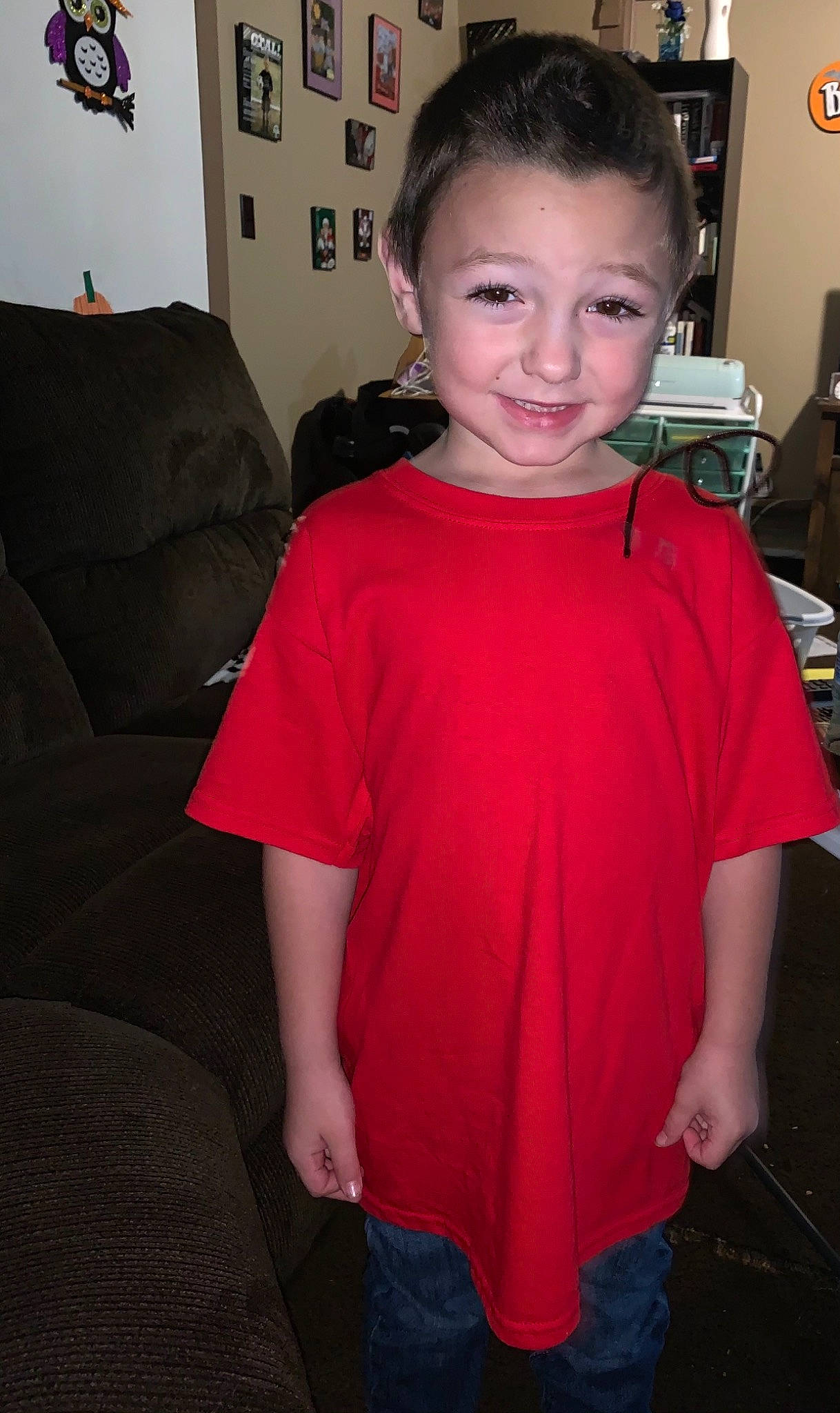 Bentley is registered to the contest to win money with this photo: aircraft, baby_toddler_clothing, couch, day_dress, joy, lamp, living_room, mouth, person, picture_frame, room, shoulder, throw_pillow, tooth