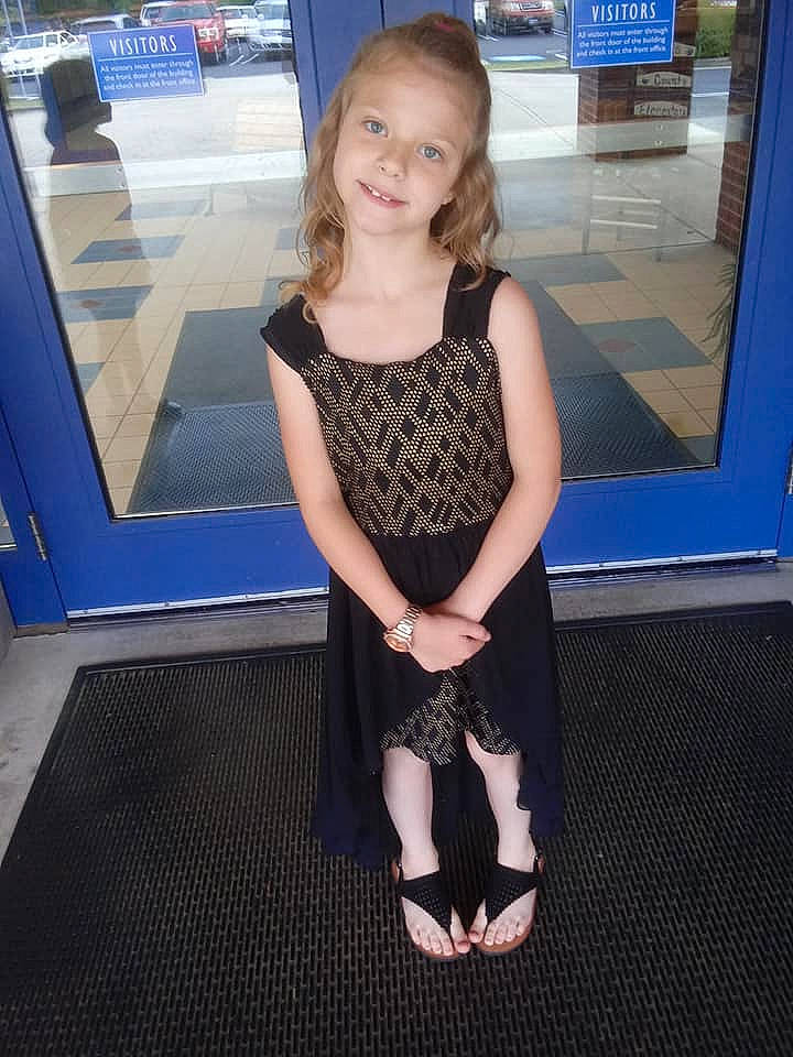 Bethany is registered to the contest to win money with this photo: arm, blue, carpet, child, child_model, dress, electric_blue, flooring, footwear, joy, leg, long_hair, person, shoe, shoulder, smile, toddler