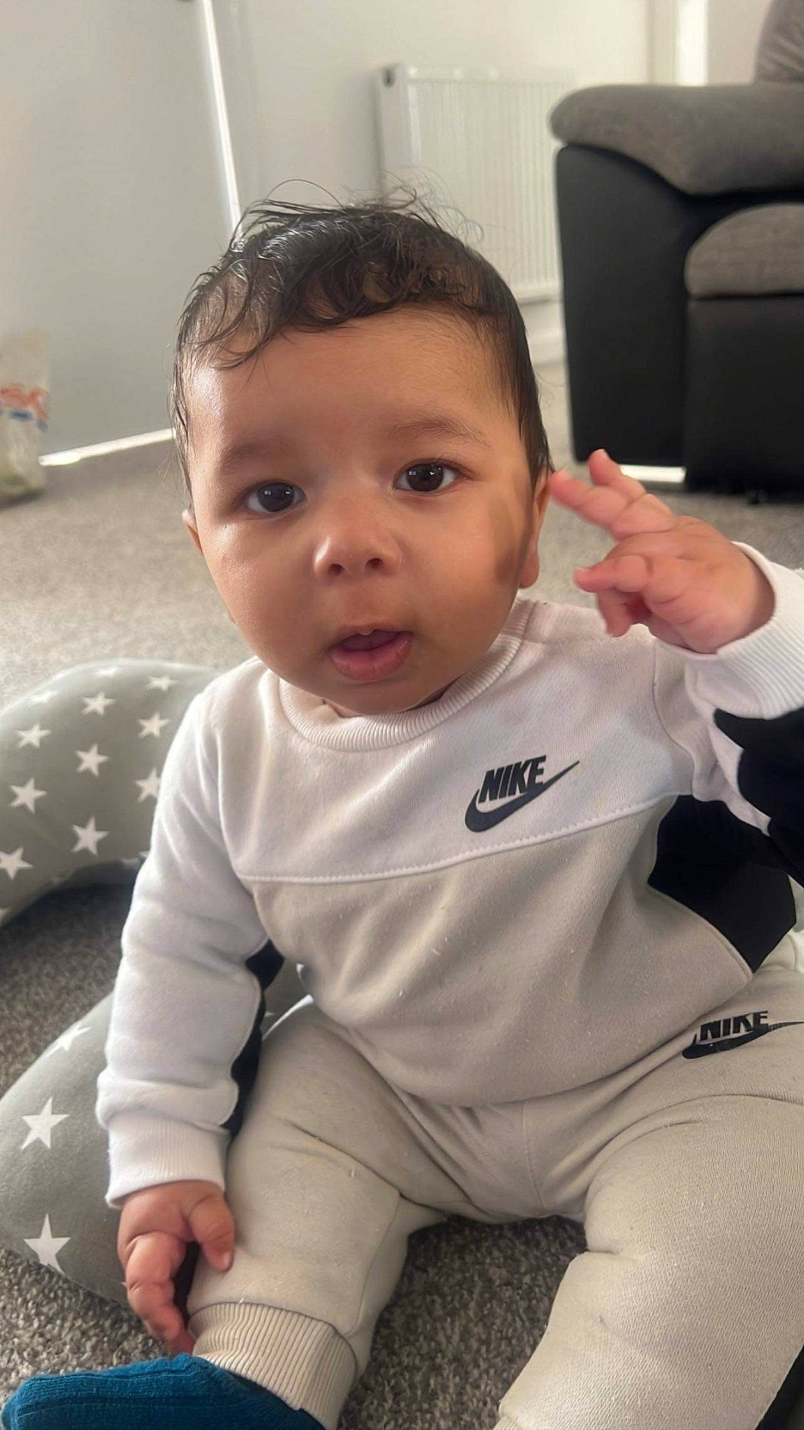 Isiah is registered to the contest to win money with this photo: arm, baby, baby_toddler_clothing, cheek, comfort, eye, facial_expression, finger, fun, gesture, hair, hand, happy, iris, mouth, nose, people, person, skin, sleeve