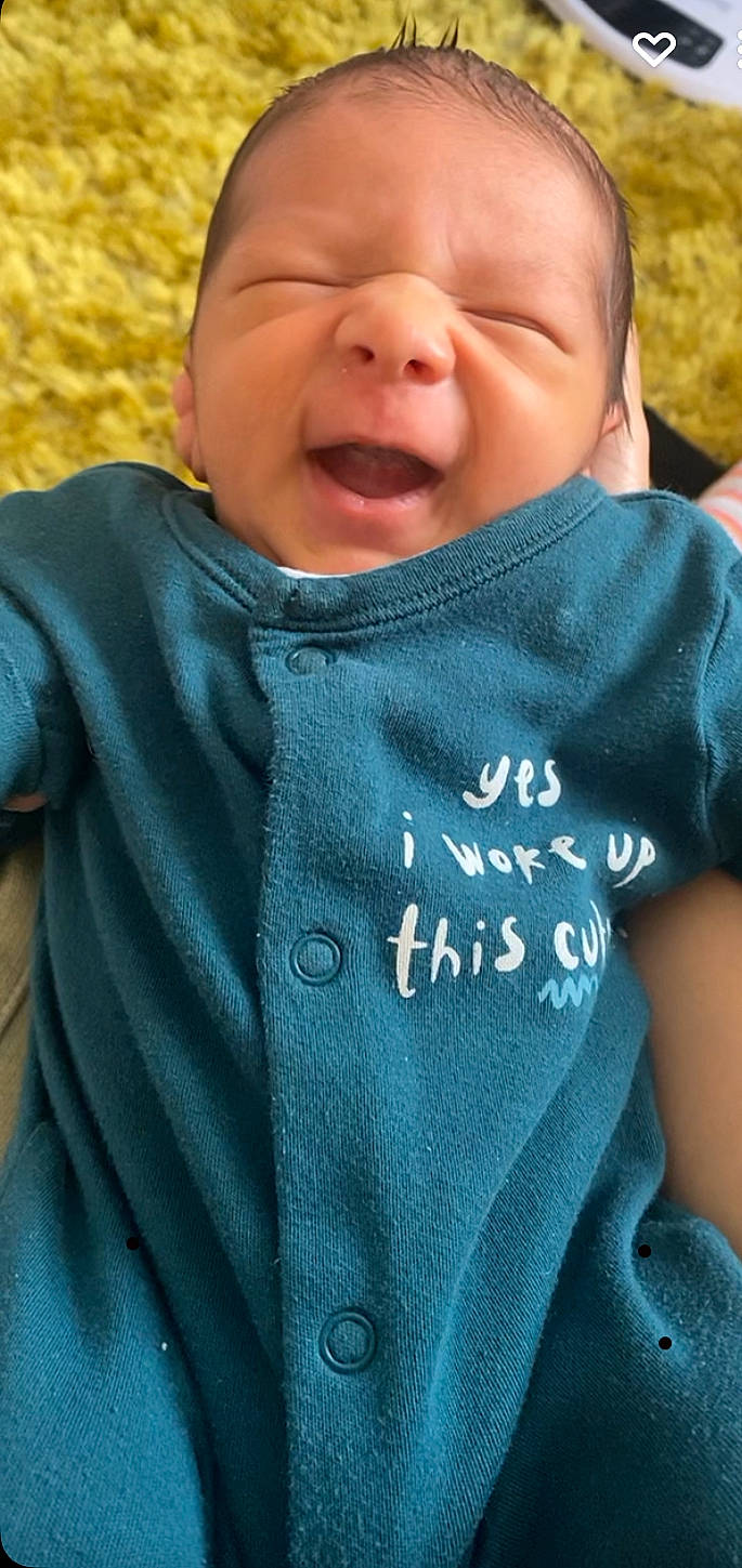 Isiah is registered to the contest to win money with this photo: azure, baby, baby_toddler_clothing, cheek, child, chin, comfort, cool, electric_blue, facial_expression, finger, grass, green, happy, people_in_nature, person, photograph, skin, sleeve, smile