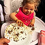 toddler, child, high_chair, messy, chocolate, cream, food, plate, pink_bib, hands, face, smiling, indoor, person, clothing, table, napkin, happy, baby, hair