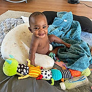 Rosigh joined the competition — help win amazing prizes! baby, blanket, can, clothing, couch, cushion, electronics, face, furniture, happy, head, homedecor, indoors, person, photography, portrait, shorts, sitting, speaker, tin