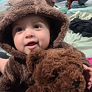 Gabriel joined the competition — help win amazing prizes! baby, child, teddy_bear, plush, costume, smile, face, hood, cute, indoor, bed, blanket, mirror, hand, furniture, soft, childhood, toy, comfort, warm