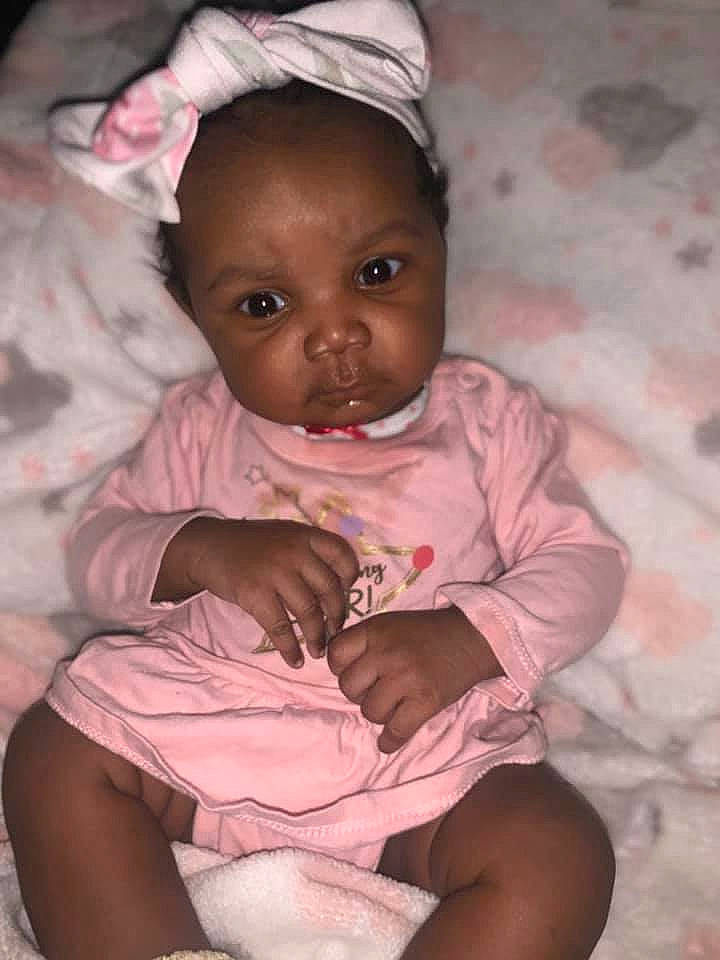 Kaelah is registered to the contest to win money with this photo: baby, baby_toddler_clothing, cheek, chin, clothing, comfort, eye, face, gesture, happy, head, iris, lip, mouth, nose, person, pink, purple, skin, sleeve