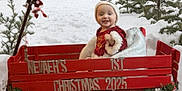 Nevaeh joined the competition — help win amazing prizes! baby, child, snow, wagon, christmas, holiday, winter, pine_trees, outdoor, festive, red, smiling, hat, decorations, garland, snowy, nature, seasonal, celebration, cute