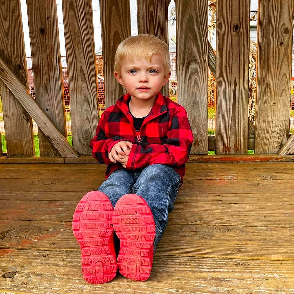 Keenan is registered to the contest to win money with this photo: baby_toddler_clothing, cheek, child, eye, face, flooring, fun, grass, happy, hardwood, jeans, leisure, outerwear, people_in_nature, person, skin, sleeve, standing, toddler, tree