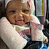 baby, infant, car_seat, pink_headband, pink_jacket, denim, cute, smiling, face, child, seatbelt, clothing, happy, portrait, indoors, closeup, headwear, baby_girl, safety, expression