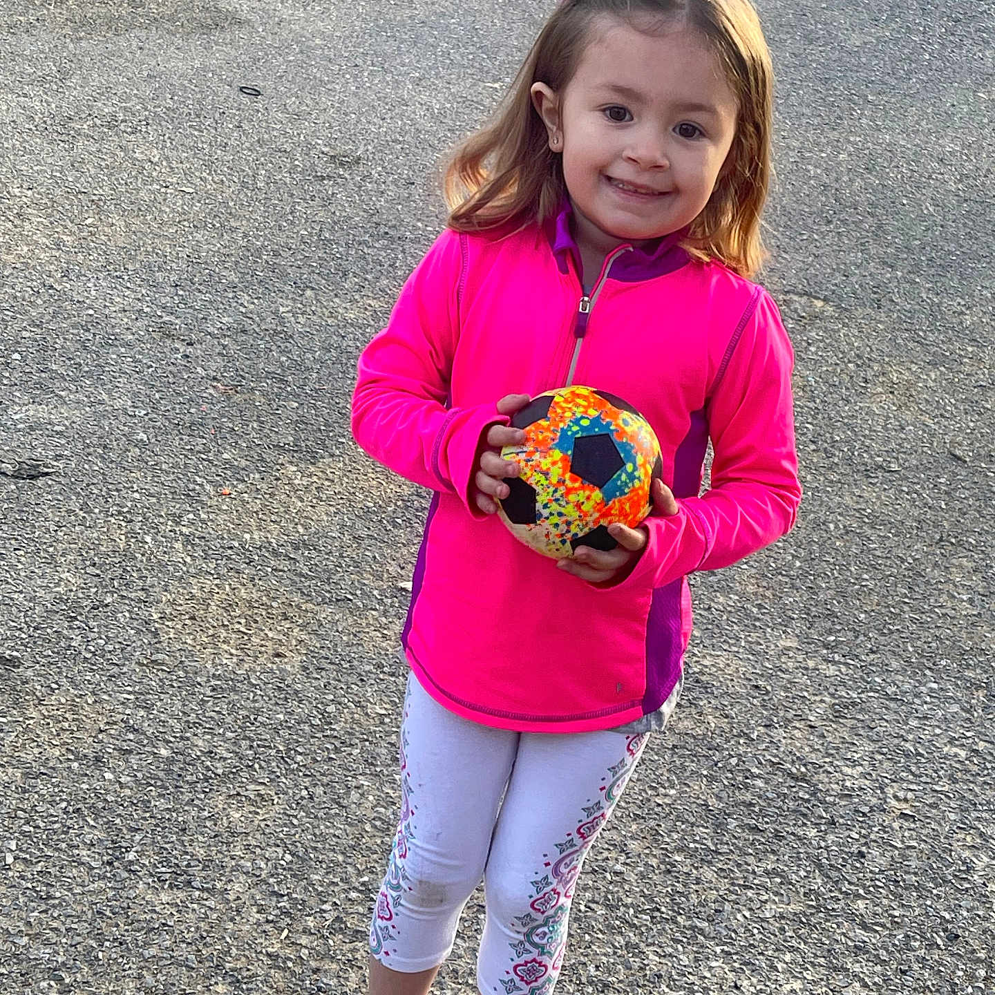 Skyler is registered to the contest to win money with this photo: ball, child, clothing, coat, face, female, food, football, girl, head, jacket, pants, person, photography, portrait, road, soccer, soccerball, sport, walking
