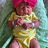 Lyla is registered to the contest to win money with this photo: baby, bassinet, blanket, child, close_up, cozy, hands, hospital, indoors, infant, newborn, patterned_fabric, photograph, pillow, pink_bow, portrait, resting, sleeping, wristbands, yellow_outfit