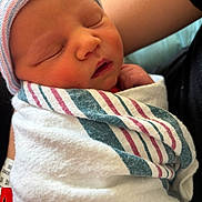 Lyla is registered to the contest to win money with this photo: arms, baby, blanket, caregiver, close_up, closed_eyes, face, hospital_blanket, indoors, infant, knit_cap, newborn, nursery, peaceful, photography, portrait, sleeping, snuggled, soft_lighting, swaddled