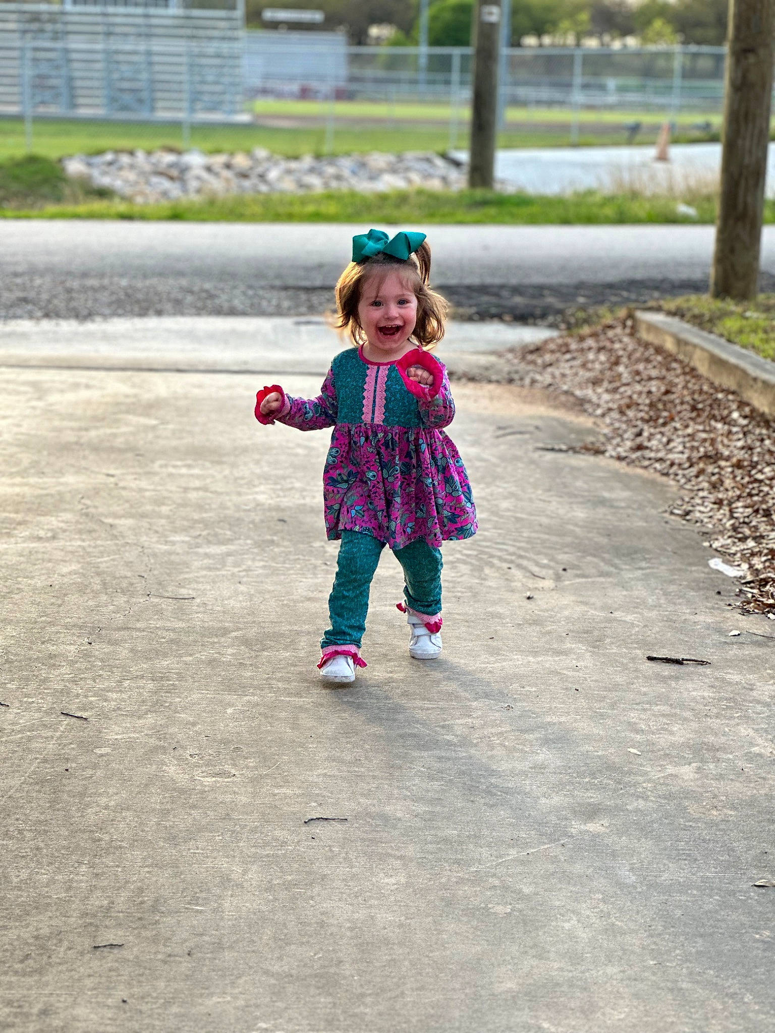 Kamdyn is registered to the contest to win money with this photo: asphalt, child, fun, grass, happy, hat, jacket, joy, leisure, magenta, pedestrian, person, pink, plant, play, recreation, road, road_surface, sidewalk, smile