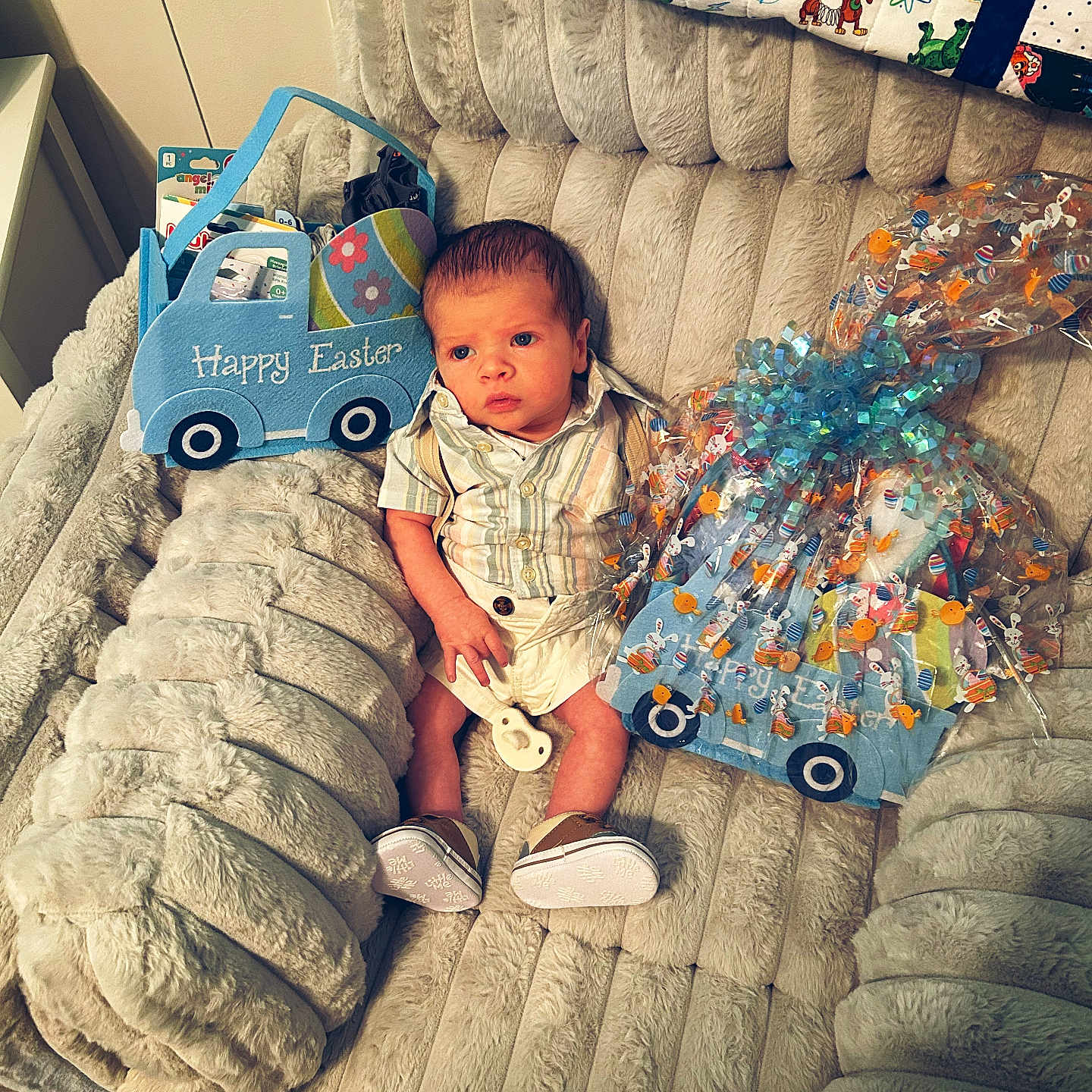 Asher is registered to the contest to win money with this photo: baby, bed, blanket, clothing, couch, crib, cushion, dress, face, footwear, furniture, head, homedecor, indoors, infantbed, person, photography, portrait, shoe, sitting