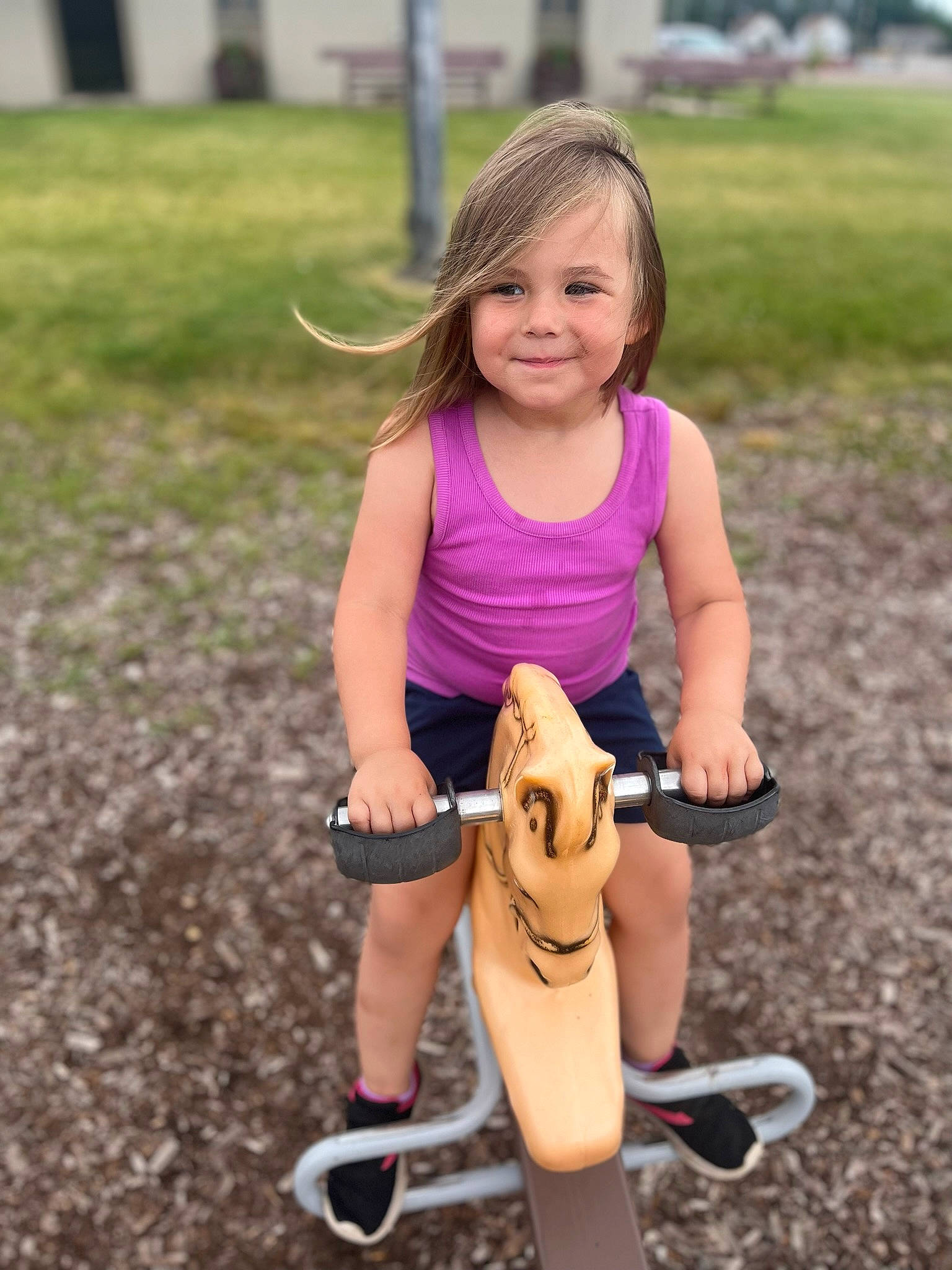 Lillieann is registered to the contest to win money with this photo: blond, child, dress, fun, grass, hair, happy, head, human_body, human_leg, joy, leisure, nature, outdoor_play_equipment, people_in_nature, person, recreation, sitting, smile, spring