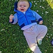 Dayvenn participe au concours pour gagner de l'argent avec cette photo : baby, child, grass, flowers, blue_jacket, pants, socks, outdoor, sunlight, shadow, nature, greenery, happy, cute, infant, person, smiling, casual_clothing, daylight, playing