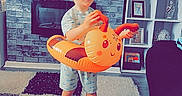 Corey joined the competition — help win amazing prizes! brick_wall, carpet, casual_clothing, child, couch, fireplace, footwear, furniture, happy, home, indoor, inflatable_toy, orange, photoframe, plant, shelf, smiling, television, toddler, toy