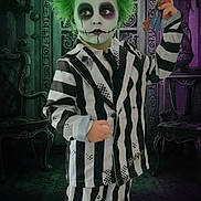 Corey is registered to the contest to win money with this photo: child, costume, face_paint, green_hair, striped_suit, keys, gothic, spooky, indoor, portrait, shoes, black_and_white, purple, chair, door, decor, fantasy, makeup, young, holiday