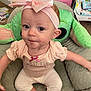 baby, child, headband, pink_bow, plush_chair, green, toy, indoor, clothing, cute, smile, face, person, infant, earrings, carpet, background, sitting, baby_gear, candid
