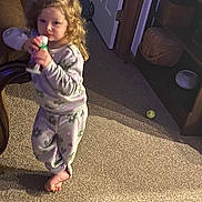 Olivia joined the competition — help win amazing prizes! ball, barefoot, basket, bottle, carpet, casual, child, cozy, curly_blonde_hair, curly_hair, door, floor, furniture, home, indoor, pajamas, person, shelf, standing, toddler