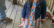 Olivia joined the competition — help win amazing prizes! barefoot, bench, casual_clothing, child, curly_hair, cute, daylight, denim_jacket, dress, footwear, girl, greenery, happy, nature, outdoor, person, portrait, smiling, wooden_floor, wooden_porch