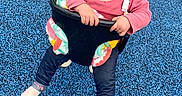Sophia joined the competition — help win amazing prizes! blanket, blue_surface, casual, child, curious_expression, feet, fun, hat, knit_hat, legs, outdoor, person, pink_sweater, play, playground, seat, swing, toddler, toy, winter_clothing