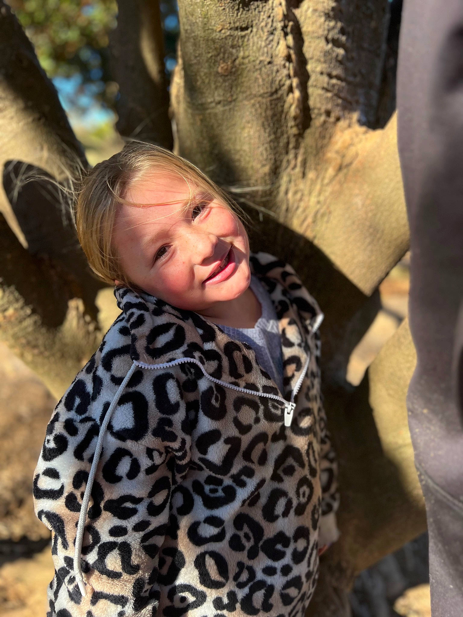 Gracelyn is registered to the contest to win money with this photo: event, facial_expression, fashion, fawn, fun, grass, hairstyle, happy, head, human, human_body, joy, leisure, organ, outerwear, people_in_nature, person, skin, smile, tree