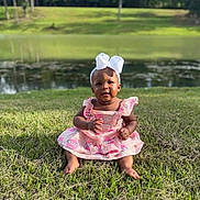 Soraya is registered to the contest to win money with this photo: baby, child, grass, pond, outdoor, nature, dress, headband, bow, smile, sitting, greenery, sunlight, cute, portrait, summer, young, infant, happy, park