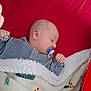 baby, bedtime, blanket, calm, child, clothing, comfort, cozy, cute, indoors, infant, newborn, pacifier, peaceful, portrait, red_background, resting, sleeping, soft_texture, warm