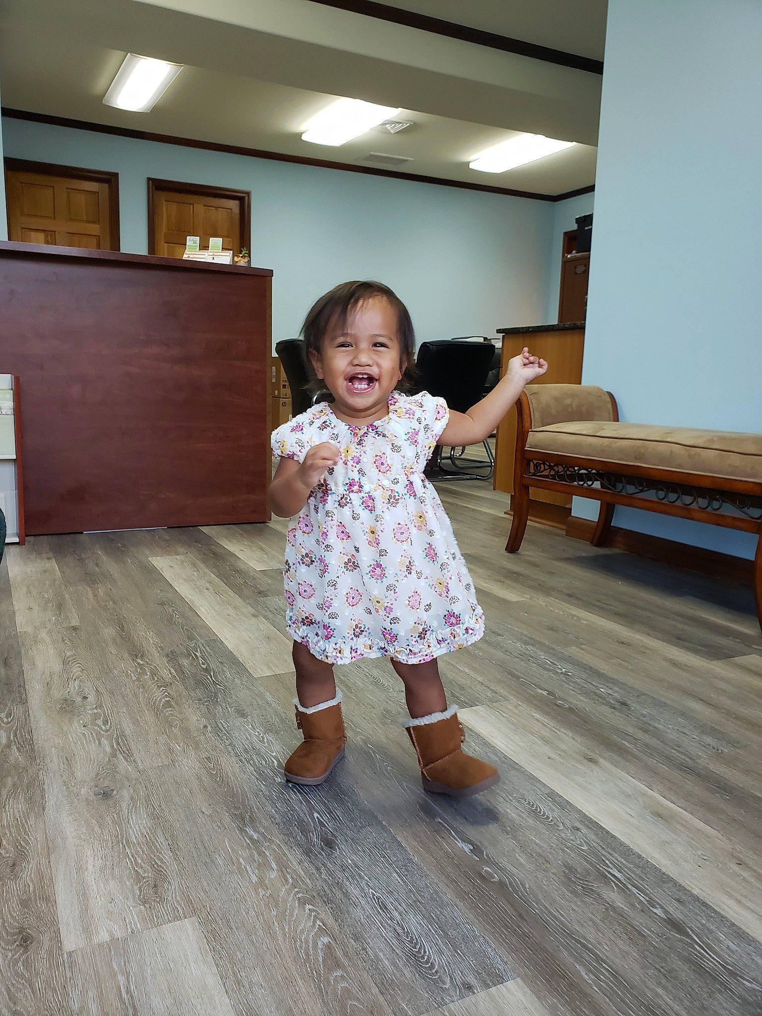 Zviana is registered to the contest to win money with this photo: beauty, child, dress, eye, floor, flooring, footwear, fun, hardwood, human_body, leg, person, room, shoe, shoulder, skin, snapshot, standing, toddler, wood