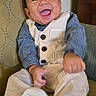baby, child, smiling, happy, sitting, clothing, vest, pants, shirt, shoes, footwear, indoor, furniture, chair, pattern, cute, portrait, infant, person, fun