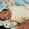 Jordan joined the competition — help win amazing prizes! baby, hoodie, mittens, dinosaur_pattern, blanket, hand, infant, clothing, soft, cute, lying_down, portrait, child, warm, comfort, newborn, person, fabric, zipper, resting
