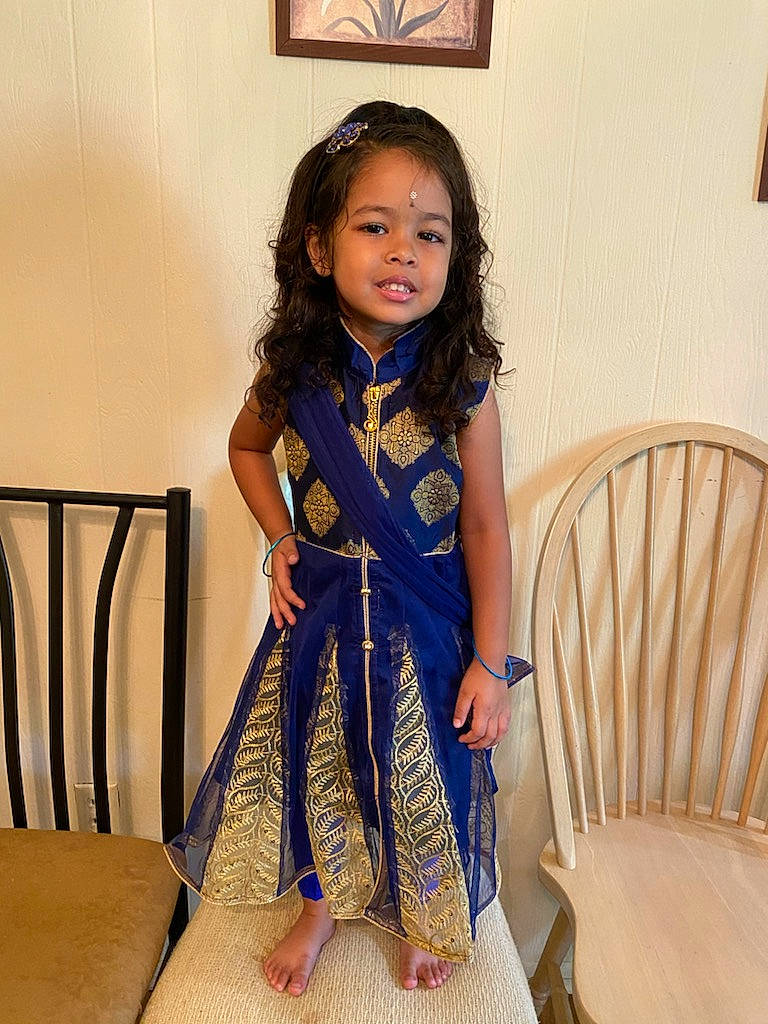 Neela joined the competition — help win amazing prizes! black_hair, chair, day_dress, dress, electric_blue, event, fashion_design, formal_wear, hair, hairstyle, joy, long_hair, neck, one_piece_garment, person, shoulder, skin, sleeve, standing, textile