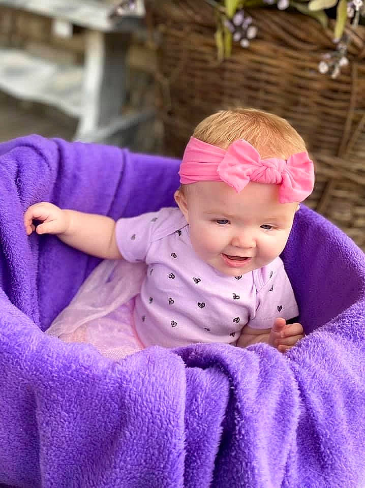 Kyrah joined the competition — help win amazing prizes! baby, baby_products, cheek, child, hair_accessory, headband, headgear, headwear, knitting, lavender, lilac, outerwear, pattern, person, pink, product, purple, skin, textile, toddler