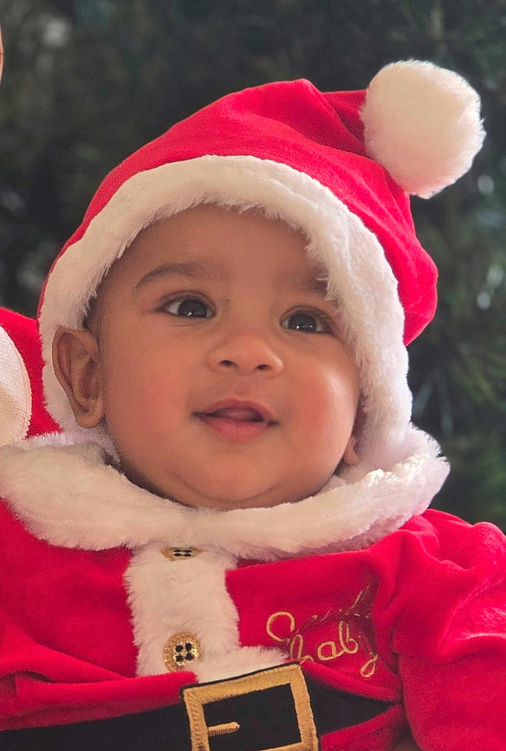 Nivaan joined the competition — help win amazing prizes! baby, child, face, smile, santa_hat, christmas, holiday, red_clothing, festive, fur_trim, cute, portrait, young_child, happy, indoors, chubby_cheeks, costume, closeup, infant, seasonal