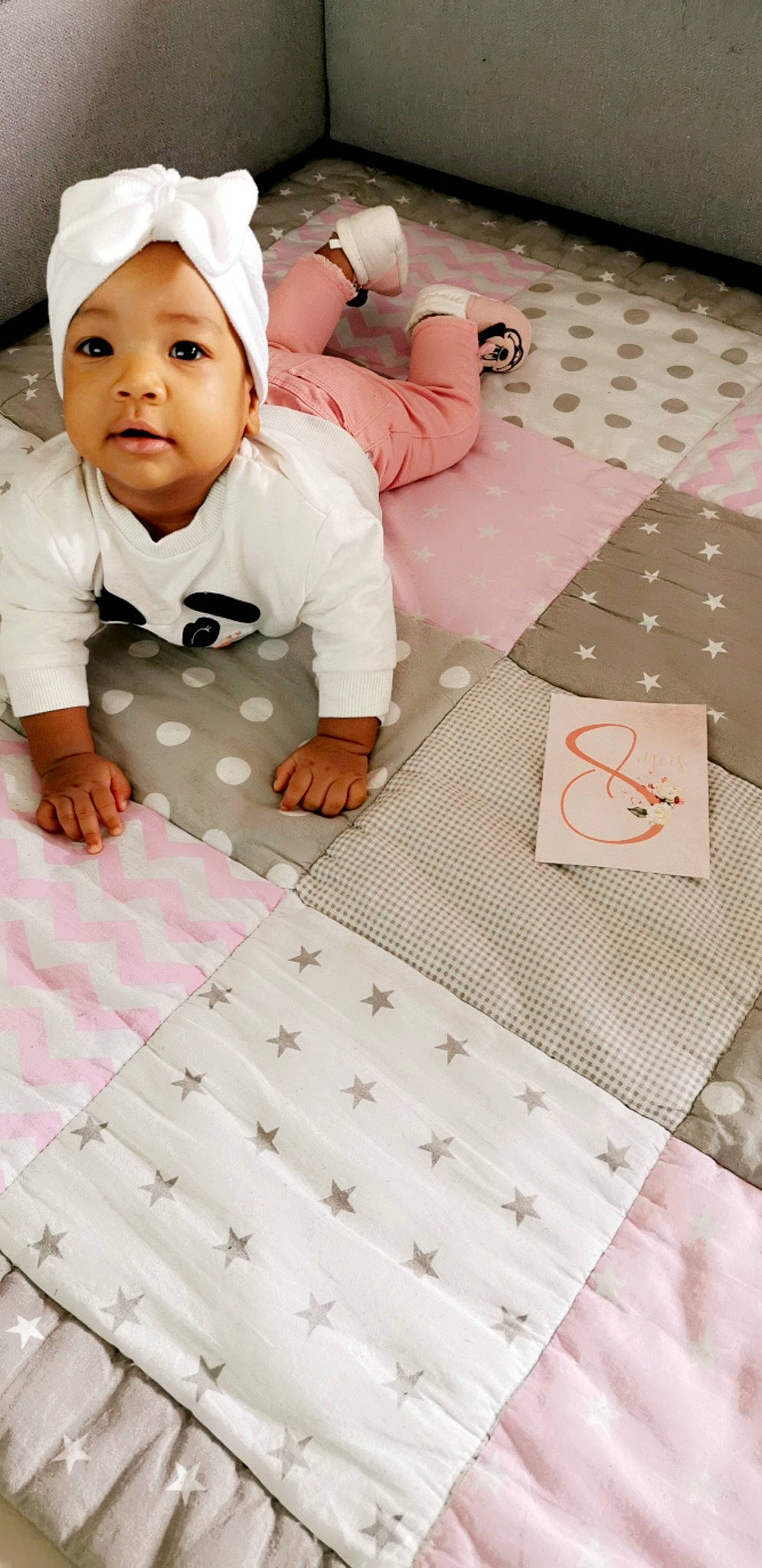 Lyannah a rejoint le concours — aidez-le/la à gagner de superbes lots ! baby, baby_toddler_clothing, child, comfort, floor, flooring, font, fun, happy, headwear, linens, pattern, person, portrait_photography, room, sitting, sleeve, t_shirt, textile, toddler