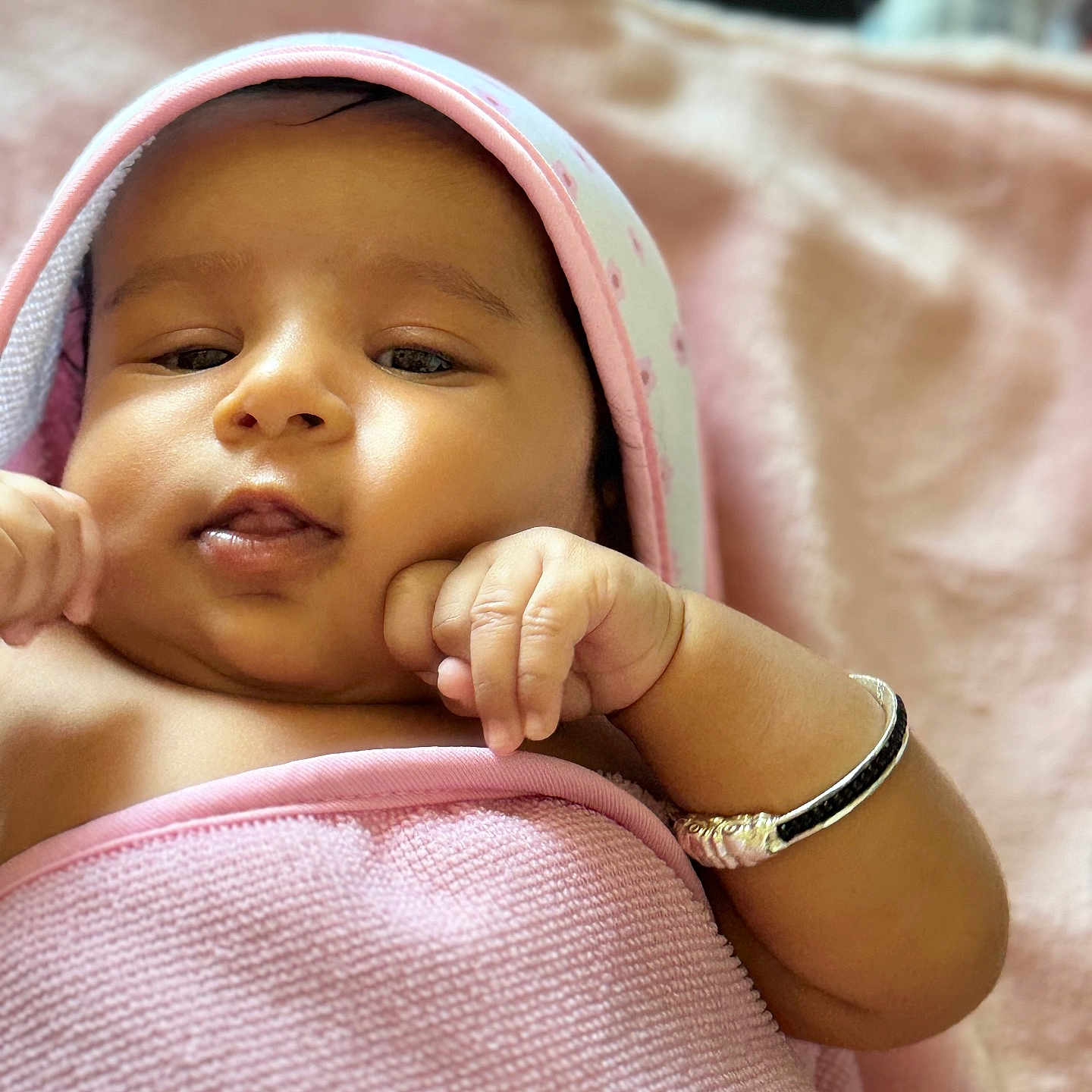 Moukthika is registered to the contest to win money with this photo: accessories, baby, blanket, bodypart, bonnet, bracelet, clothing, face, finger, hand, happy, hat, head, jewelry, newborn, person, photography, portrait, smile, towel