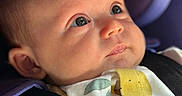 Murphy joined the competition — help win amazing prizes! baby, infant, face, car_seat, seatbelt, close_up, child, portrait, cute, expression, clothing, straps, sitting, indoors, head, skin, eyes, small_person, young_child, baby_clothes