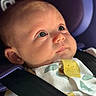 baby, infant, face, car_seat, seatbelt, close_up, child, portrait, cute, expression, clothing, straps, sitting, indoors, head, skin, eyes, small_person, young_child, baby_clothes