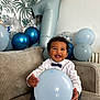 Noah participe au concours pour gagner de l'argent avec cette photo : toddler, balloon, birthday, number_one_balloon, crown_balloon, smiling_child, couch, indoor, party_decorations, bow_tie, white_shirt, happy, celebration, blue_balloons, silver_balloons, curly_hair, child, portrait, home, decor