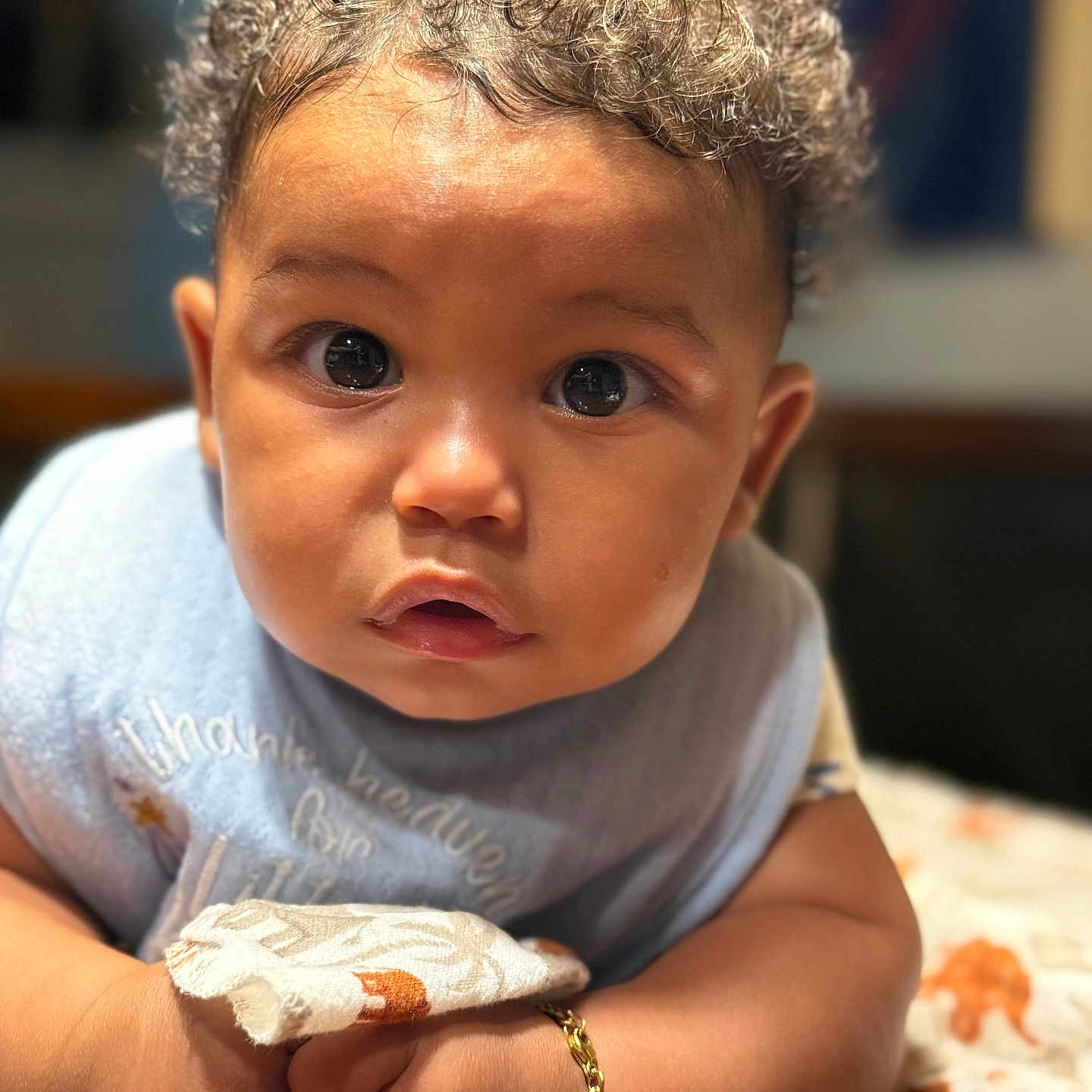 Jay joined the competition — help win amazing prizes! baby, bracelet, child, close_up, cloth, curious, curly_hair, cute, expression, eyes, face, hands, indoor, infant, innocent, portrait, skin, soft_focus, toddler, wooden_surface