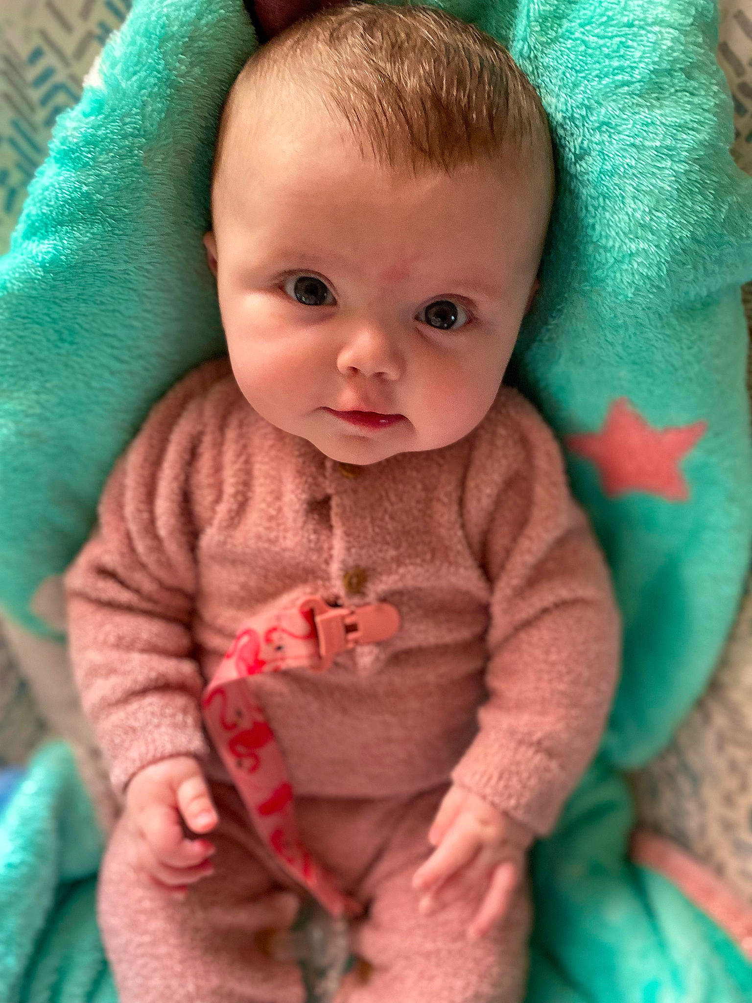 Ariana is registered to the contest to win money with this photo: baby, baby_toddler_clothing, cheek, chin, eye, face, green, head, iris, lip, mouth, nose, organ, person, pink, product, skin, sleeve, standing, textile