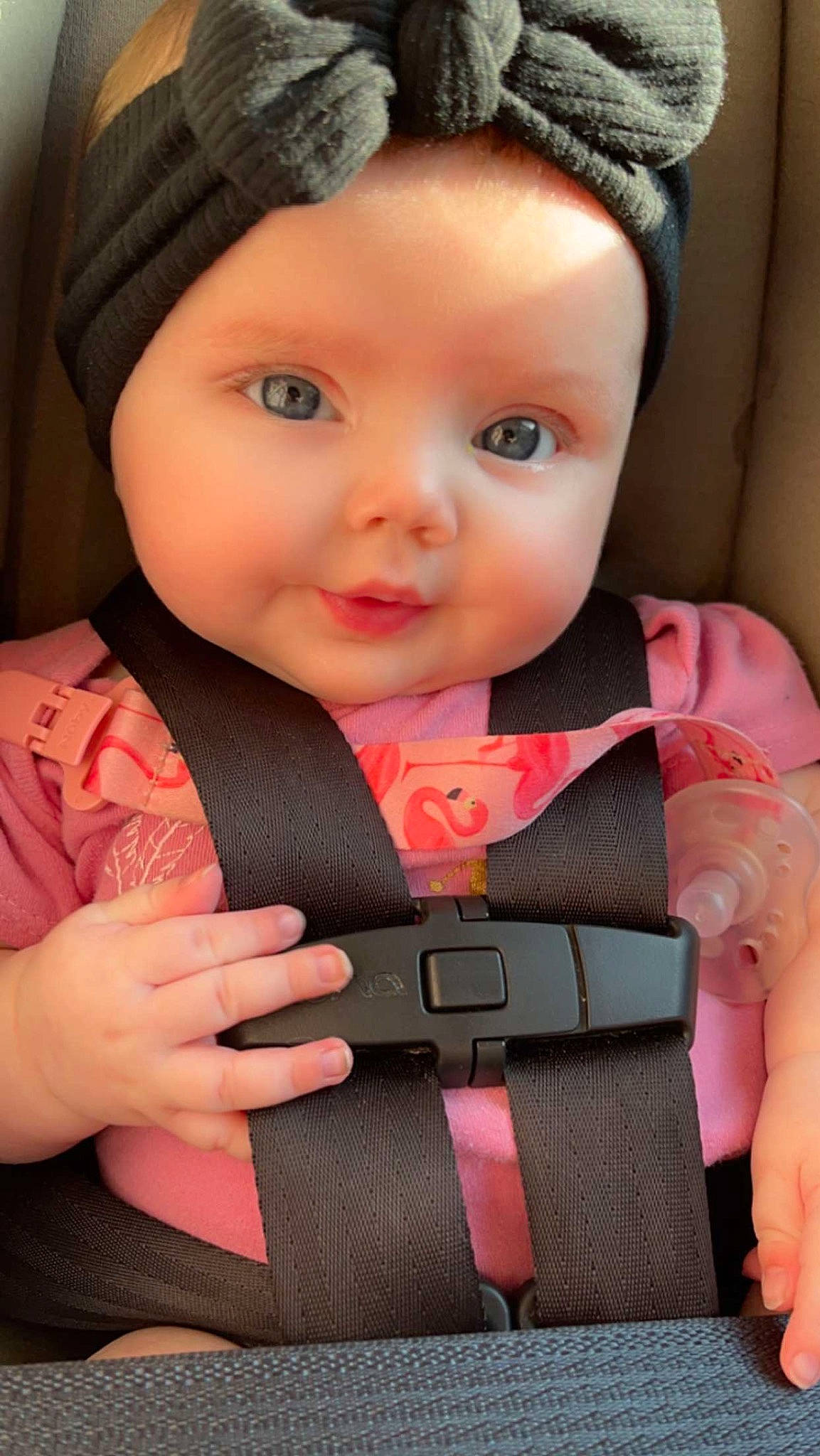 Ariana joined the competition — help win amazing prizes! baby, baby_carriage, baby_toddler_clothing, cap, cheek, chin, dress, eye, face, finger, hairstyle, hand, head, headwear, lip, neck, outerwear, person, pink, seat_belt