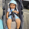 Haytam participe au concours pour gagner de l'argent avec cette photo : accessories, alloywheel, baby, baseballcap, cap, car, clothing, face, hat, head, machine, person, photography, portrait, strap, stroller, sunhat, transportation, vehicle, wheel