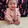 baby, child, smiling, pink_bows, pink_outfit, checkered_clothing, carpet, butterfly_pattern, black_blanket, happy, cute, portrait, indoor, sitting, infant, toes, long_sleeves, hair_bows, cheerful, adorable