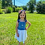 blue_sky, casual_clothing, child, crocs, denim, dress, girl, grass, greenery, happy, headband, nature, outdoor, person, portrait, smiling, standing, summer, sunny, young