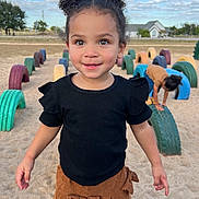Leilani is registered to the contest to win money with this photo: architecture, building, child, clothing, face, female, girl, hair, head, machine, nature, outdoors, pants, person, photography, portrait, shorts, summer, t_shirt, wheel