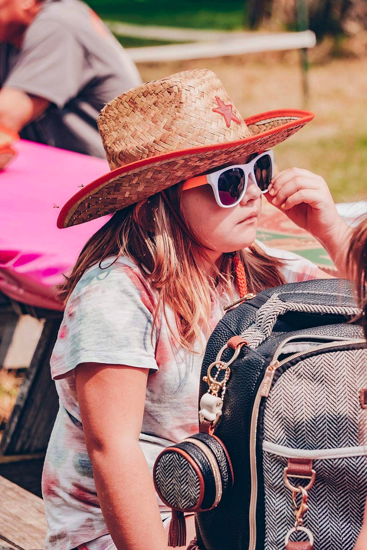 Charlene is registered to the contest to win money with this photo: cool, crowd, daytime, eyewear, fashion, fun, glasses, goggles, hairstyle, happy, hat, headgear, leisure, person, photograph, red, street_fashion, style, sun_hat, sunglasses